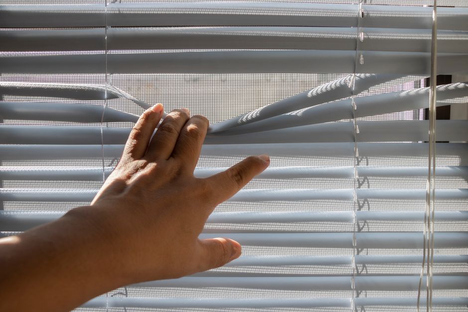 Professional installer adjusting a new window shade
